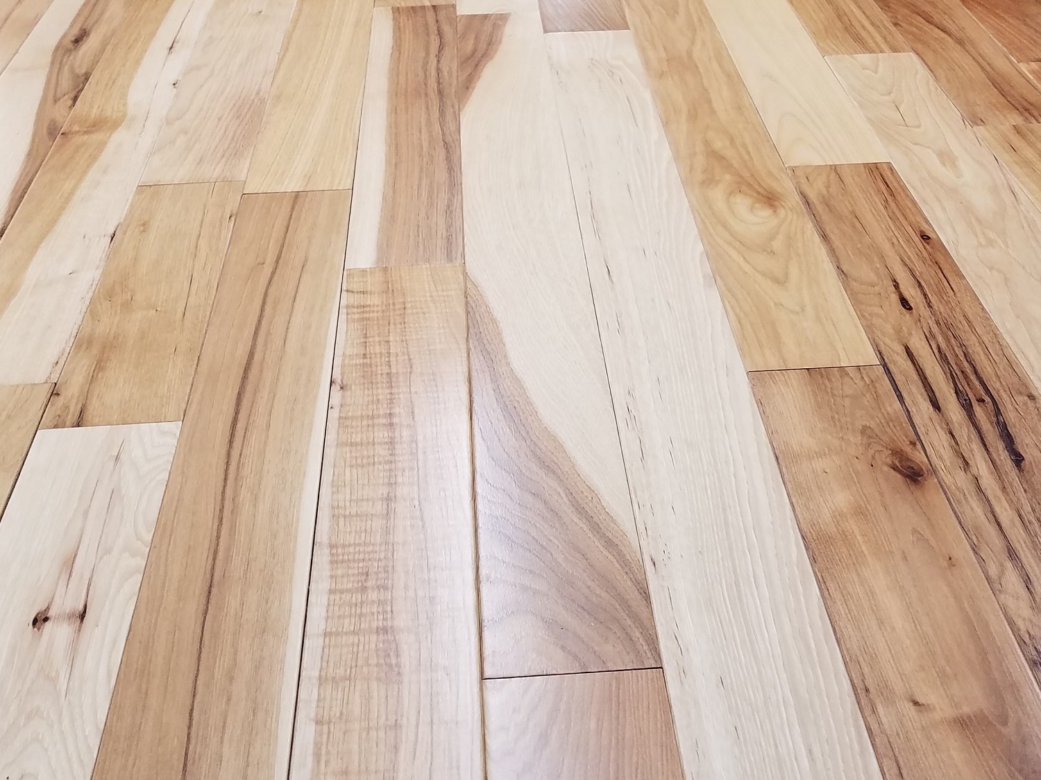 Close-up of Appalachian solid hardwood flooring showing natural color and grain variation in Virginia-crafted planks.