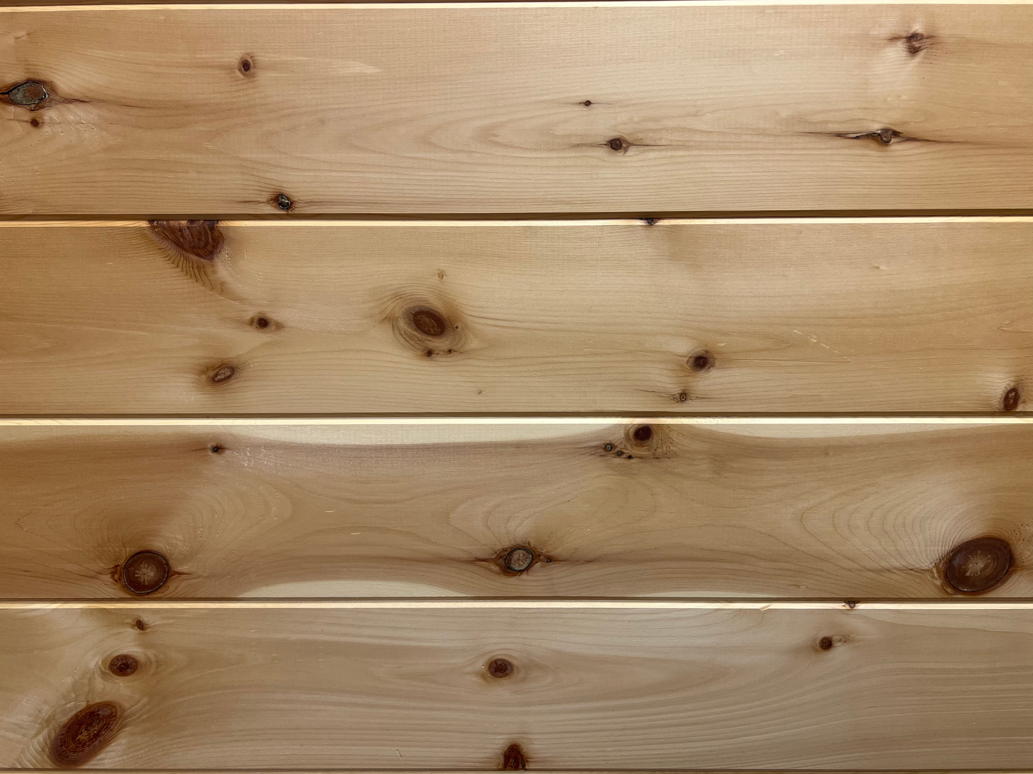 Flat-side Eastern White Pine tongue-and-groove wall planks made from Virginia Appalachian wood, showing natural knots and grain variation.