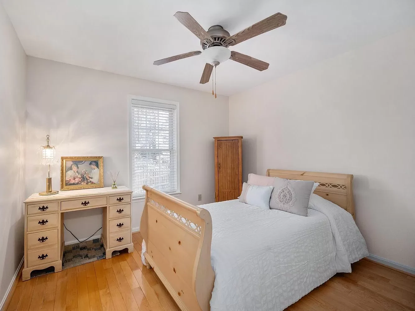 Red Oak Bedroom Flooring Natural Red Oak hardwood flooring installation in a bedroom with a ceiling fan and light wood furniture.