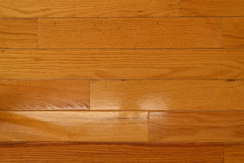 Character grade Red Oak prefinished hardwood flooring with a Golden stain and micro-bevel edges.