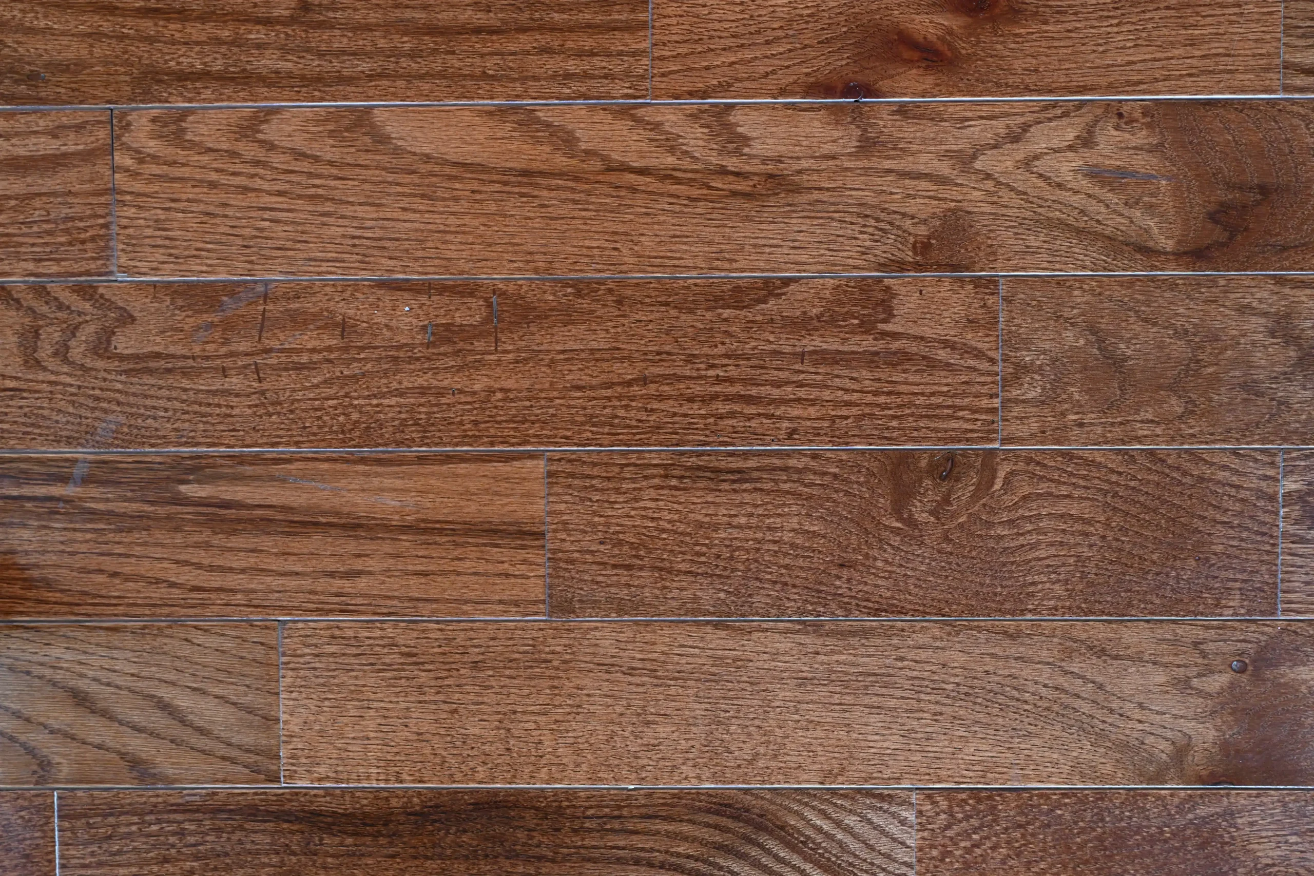 Warm Walnut Red Oak Character grade Warm Walnut Red Oak prefinished hardwood flooring with micro-bevel edges.