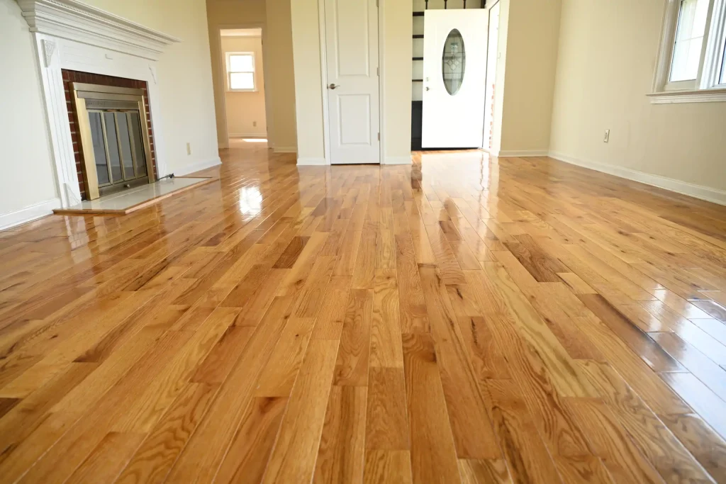 Character Golden Oak Red Oak flooring in a living room and entryway with a white fireplace and semi-gloss finish.