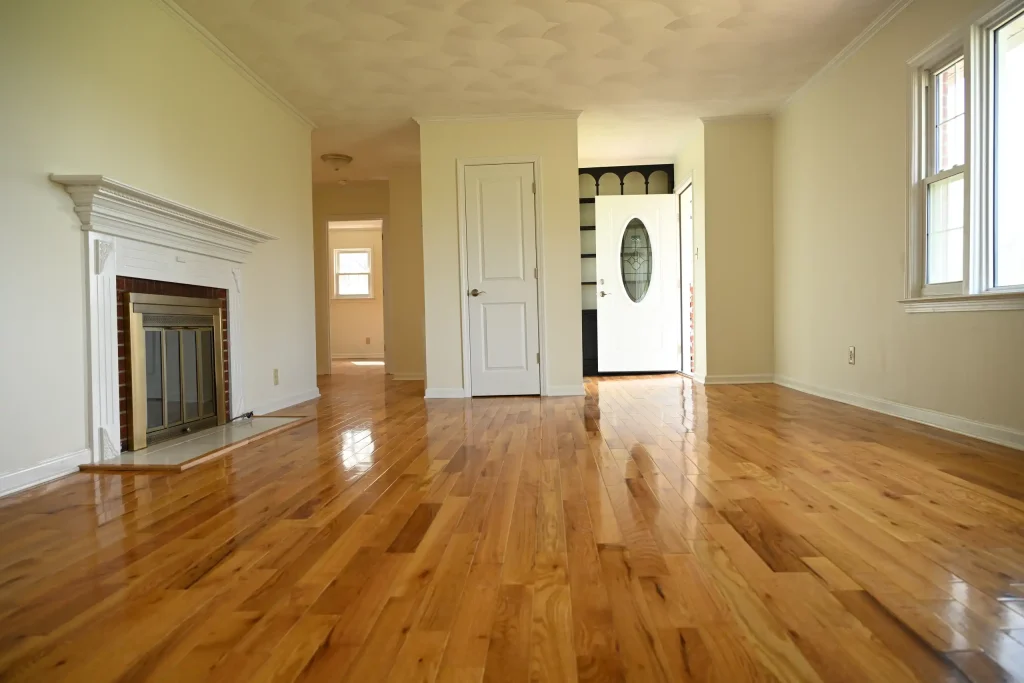 Character Golden Oak Red Oak flooring in a semi-gloss finish featured in a living room and entryway with a fireplace.